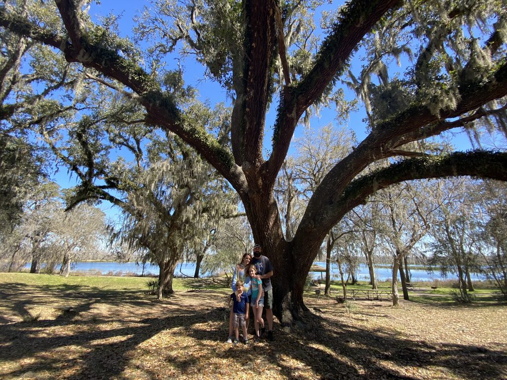family under oak tree