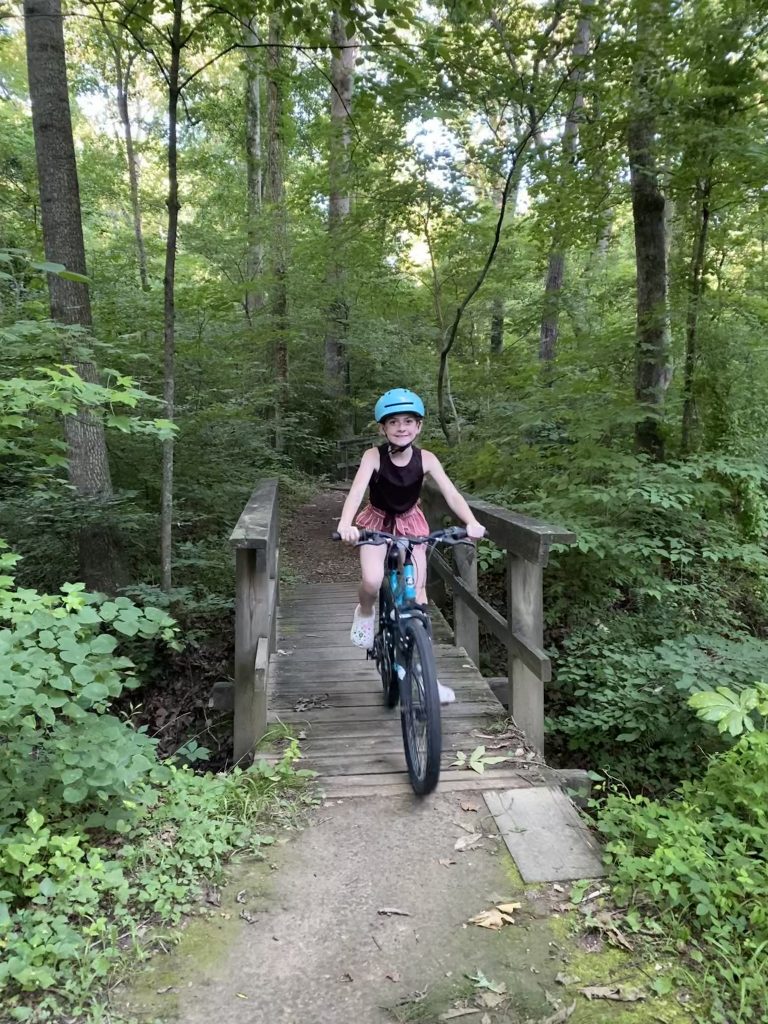 girl riding bike on trail