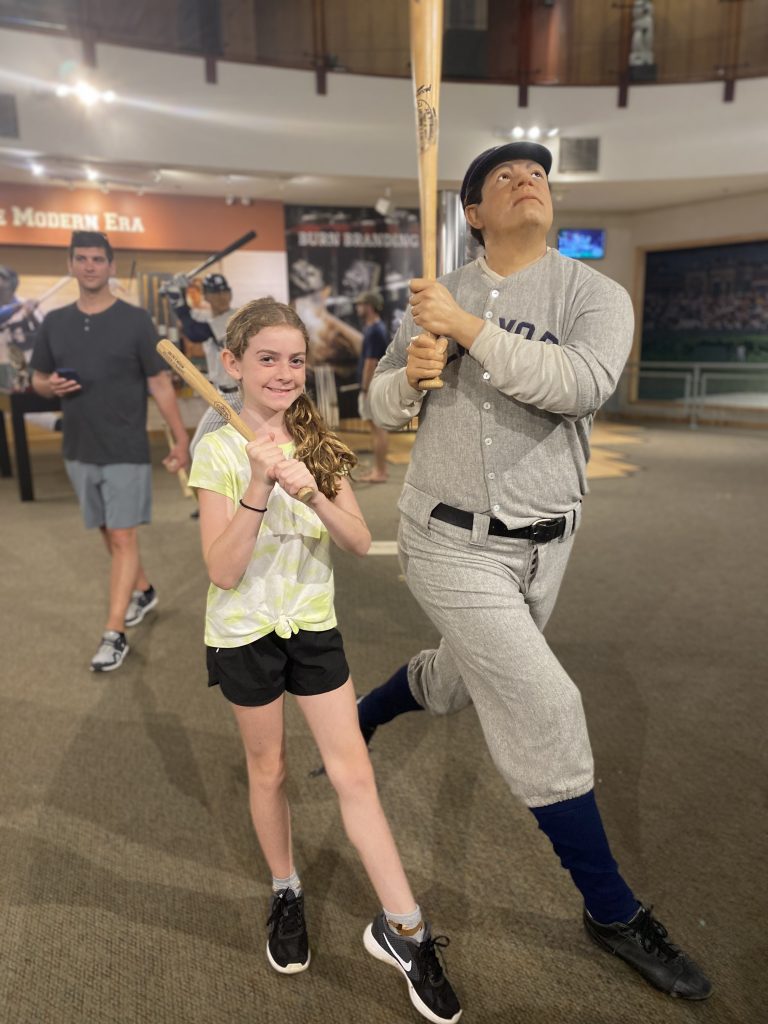 child posing with Babe Ruth